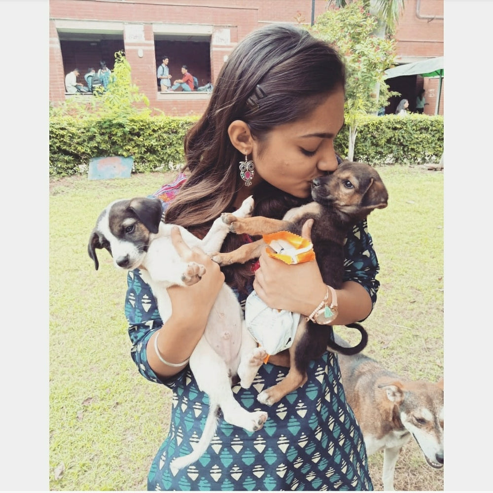 woman holding puppies in her hand