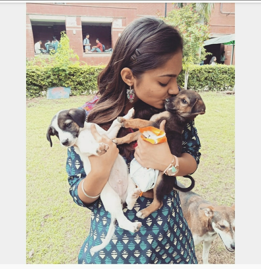 woman holding puppies in her hand