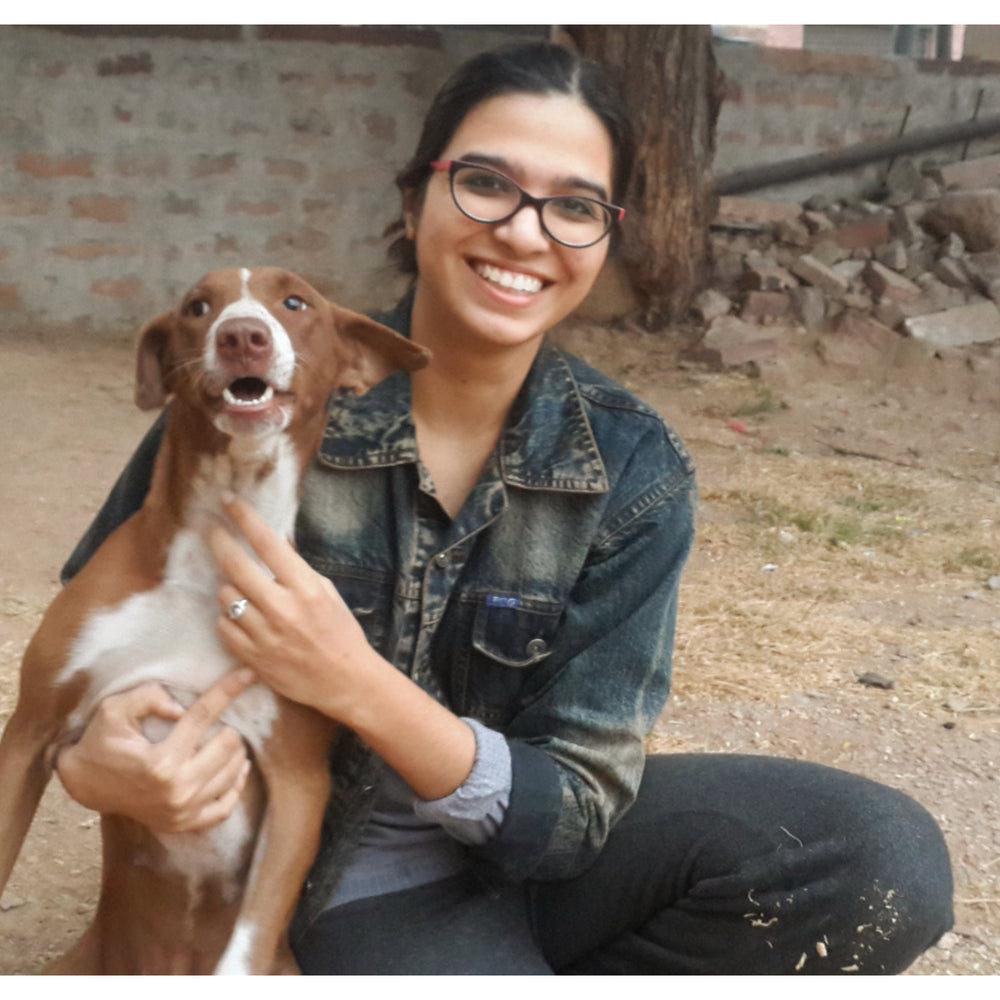 Woman with a dog sitting outdoors